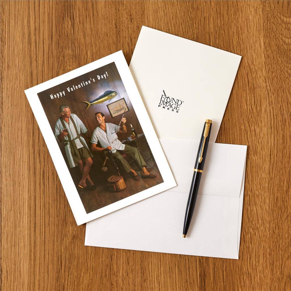 Valentine's Day card with illustration of two men, an envelope, and a pen on a wooden surface.