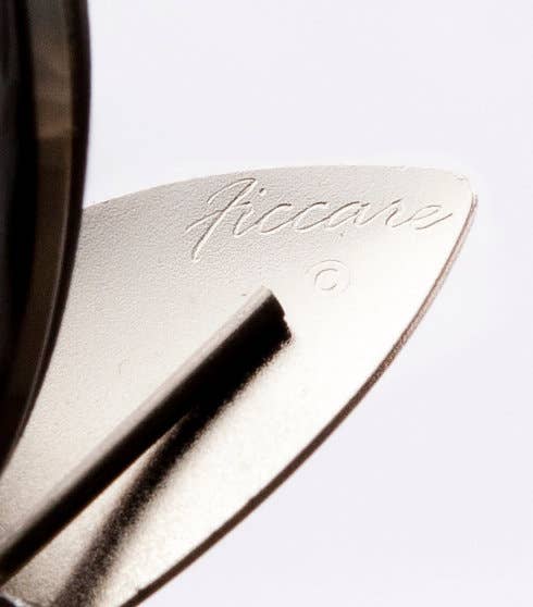 Close-up of a metallic object with 'Ficara' branding on a white background