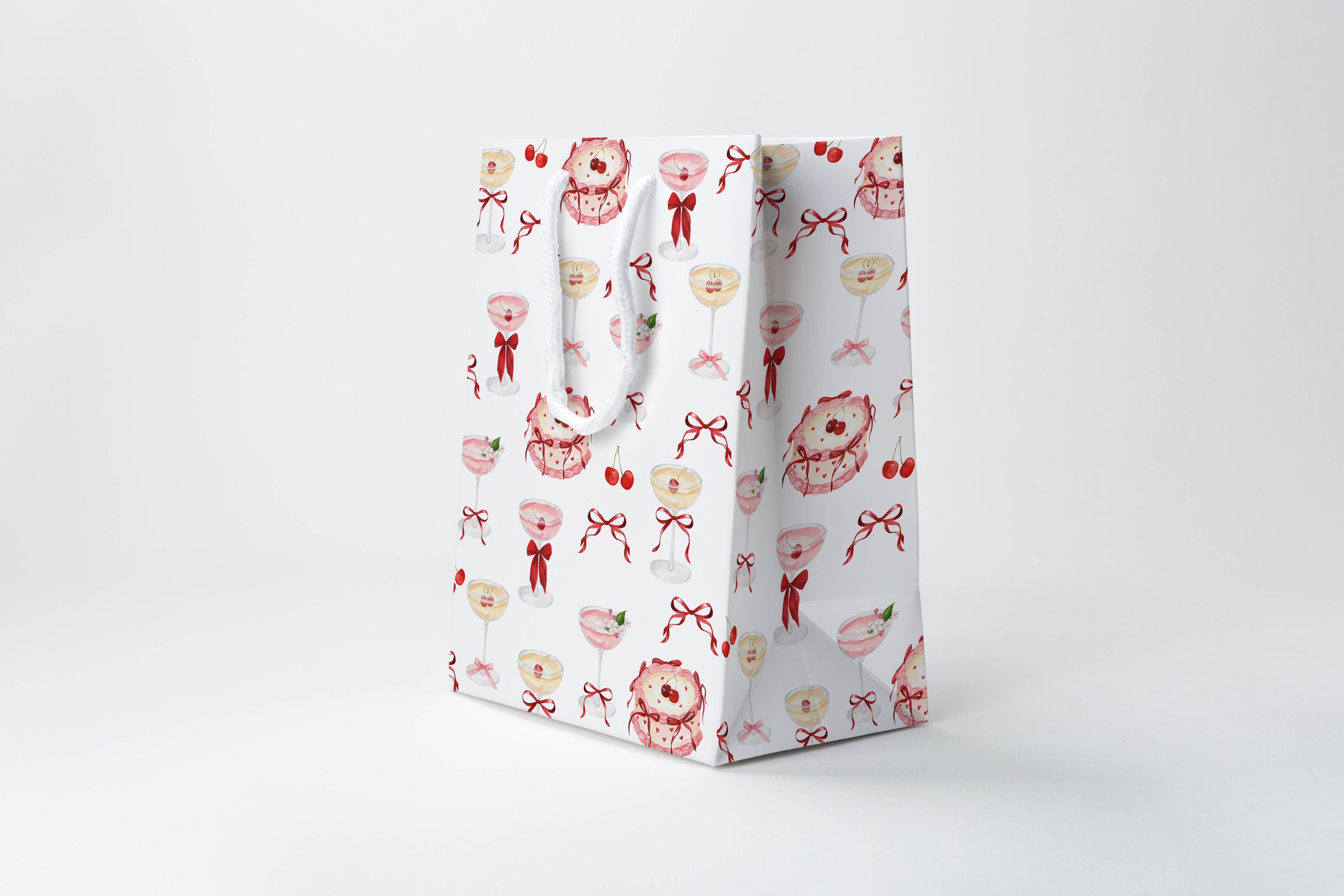Gift bag with floral and bow pattern on a white background