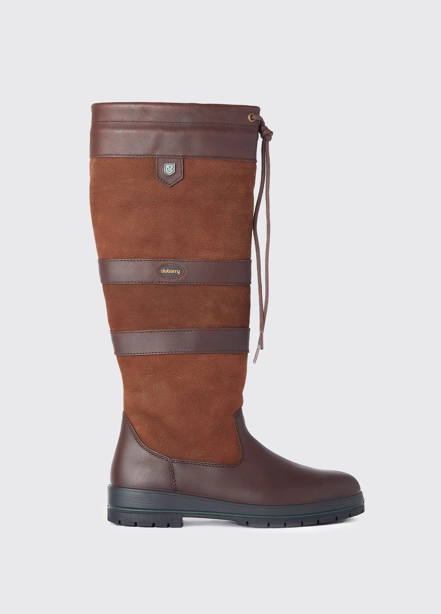 Brown riding boot with a strap on a light gray background