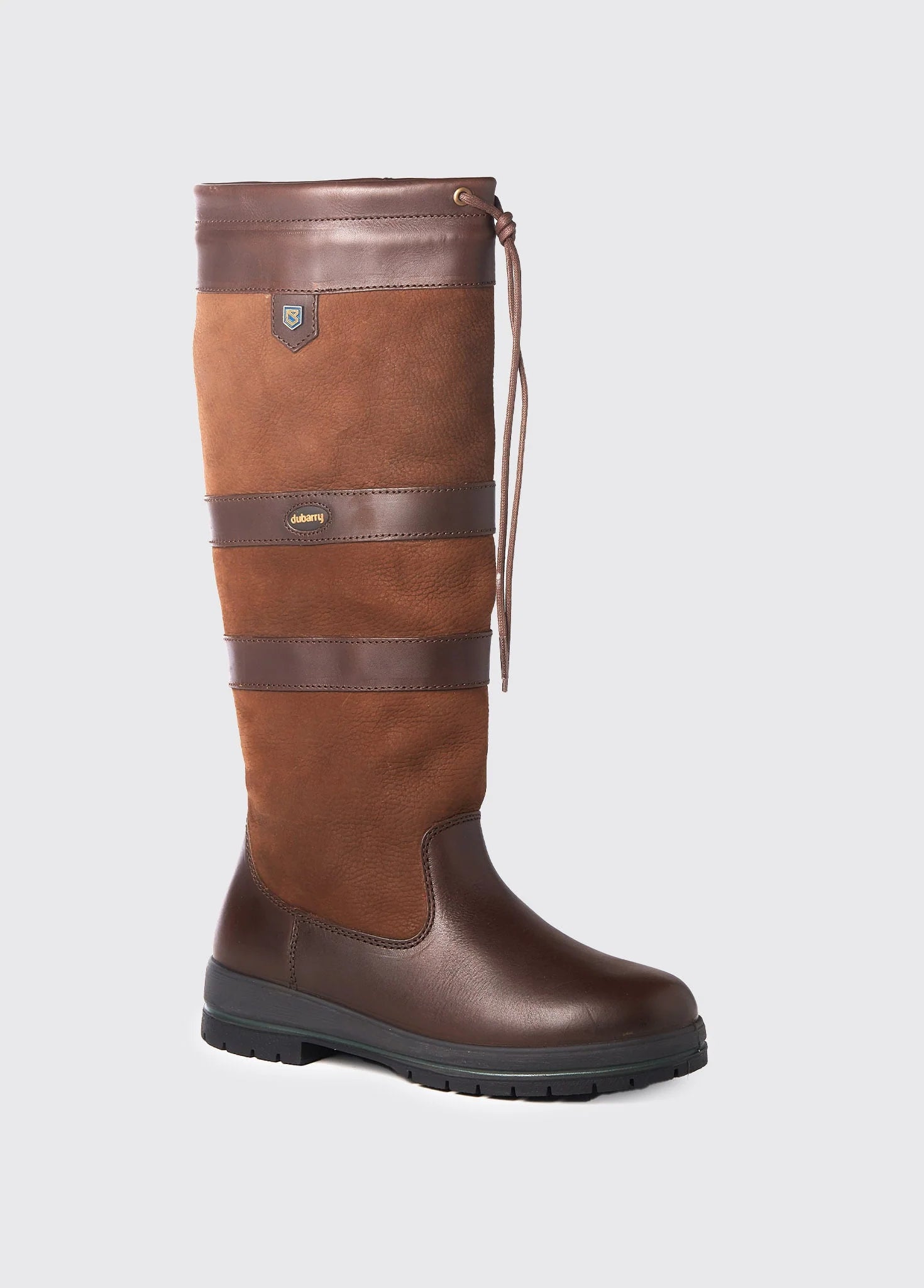 Brown leather boot with a strap on a light gray background