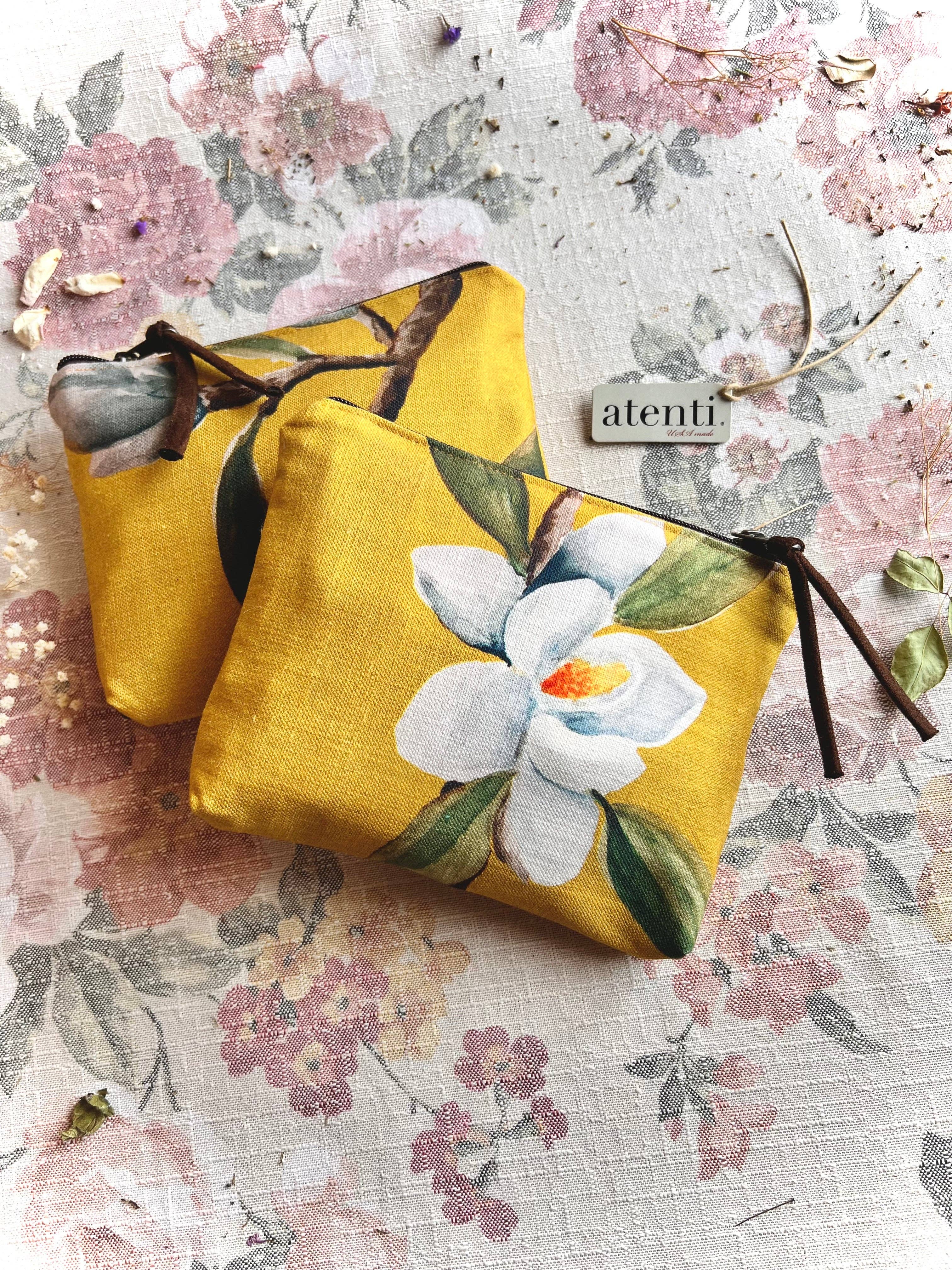 Yellow pouch with floral design on a floral background