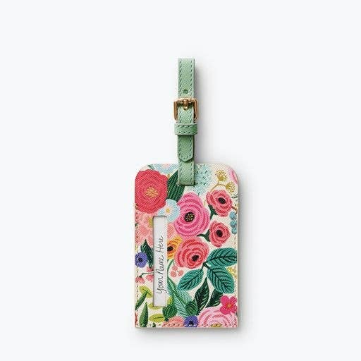 Floral luggage tag with a green strap on a white background