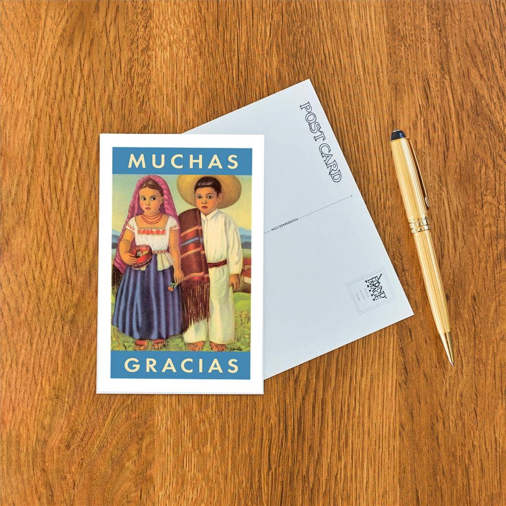 Postcard with illustration of two people and 'Muchas Gracias' text on a wooden surface with a pen.