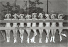 Vintage black and white photo of women in cowboy hats and boots posing outdoors.