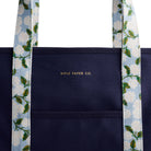 Navy tote bag with floral straps featuring 'Rifle Paper Co.' branding.