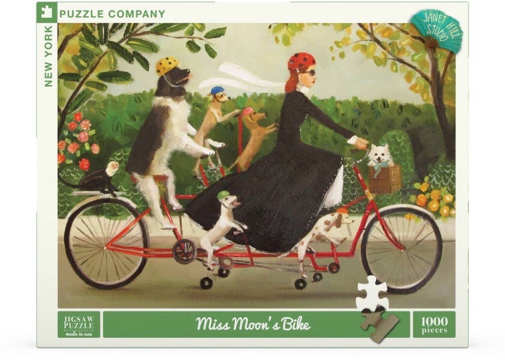 Jigsaw puzzle packaging featuring a woman on a tandem bicycle with dogs, labeled 'Miss Moon's Bike'.