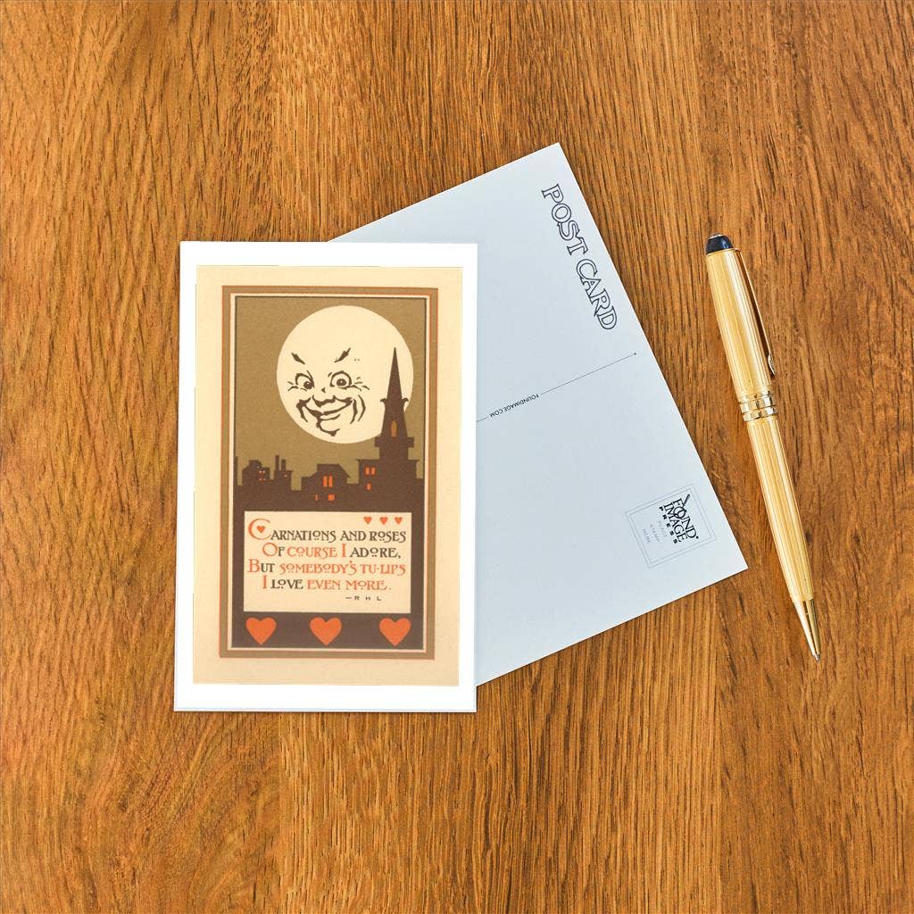 Greeting card with illustration and text on a wooden surface with a pen.