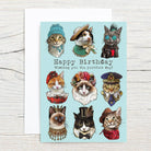 Birthday card with illustrated cats in costumes on a light blue background