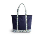 Navy tote bag with floral-patterned handle on a white background