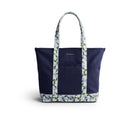 Navy tote bag with floral patterned handle and base on a white background