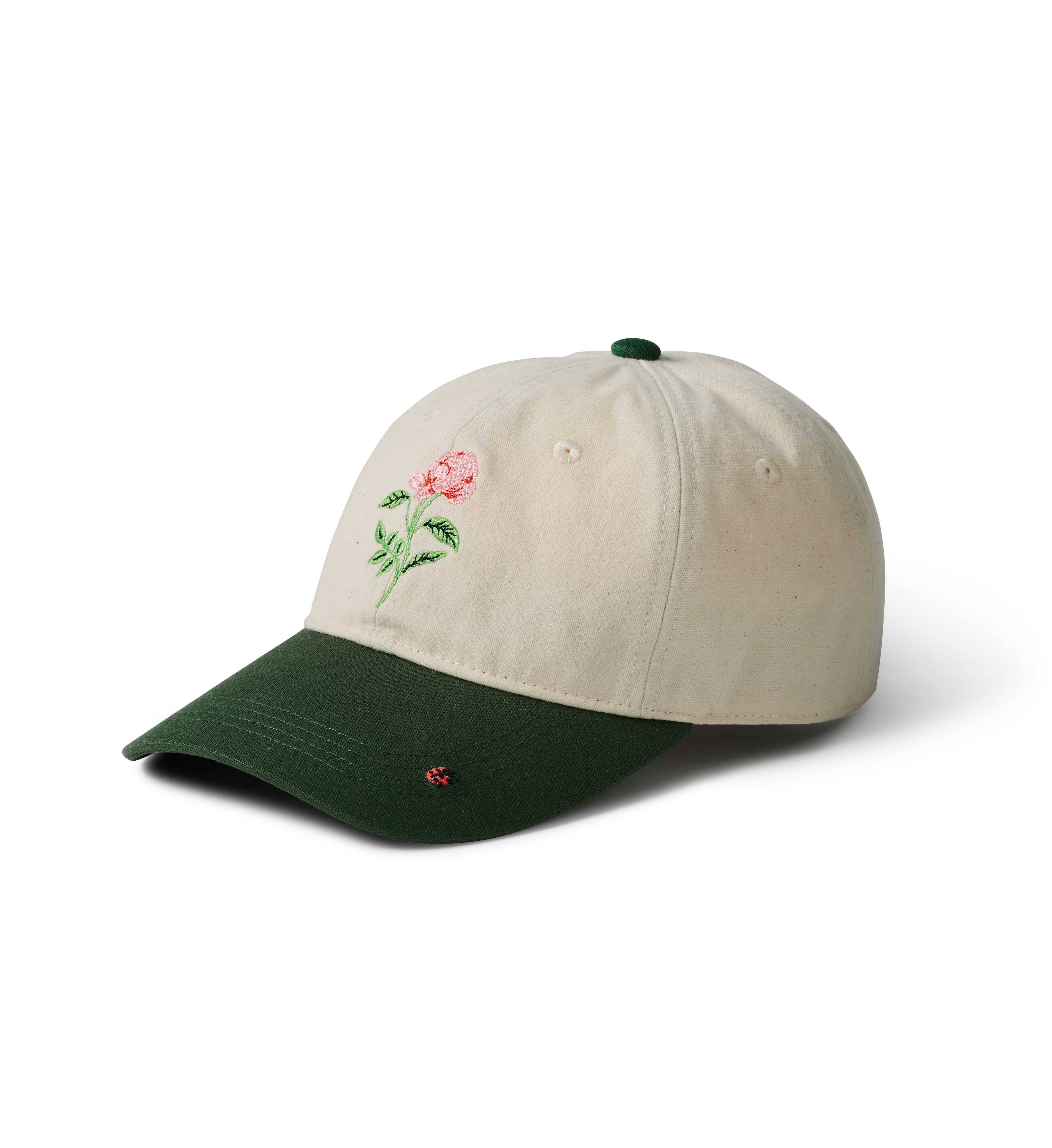 Beige cap with embroidered rose design on a white background