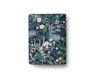 Floral and peacock patterned notebook on a white background