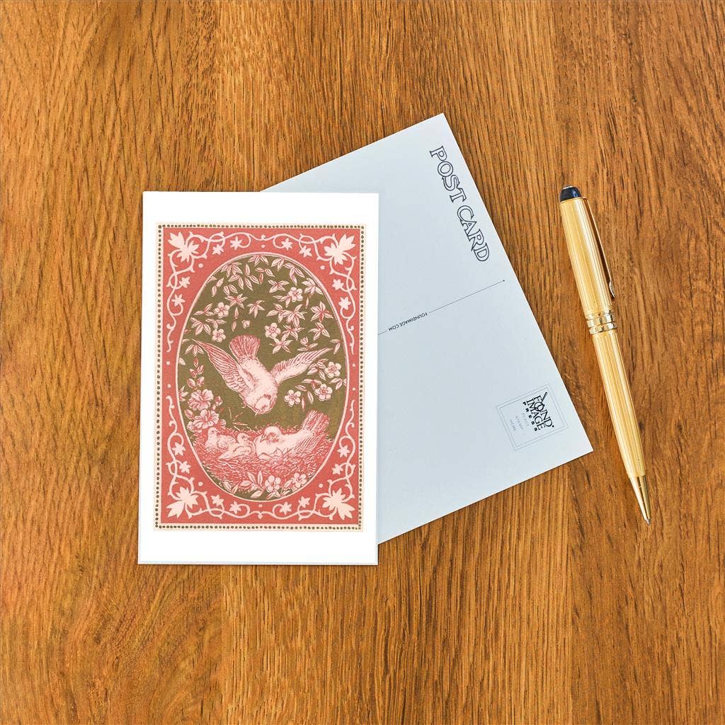 Decorative postcard with a gold pen on a wooden surface