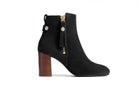 Black ankle boot with wooden heel on a white background
