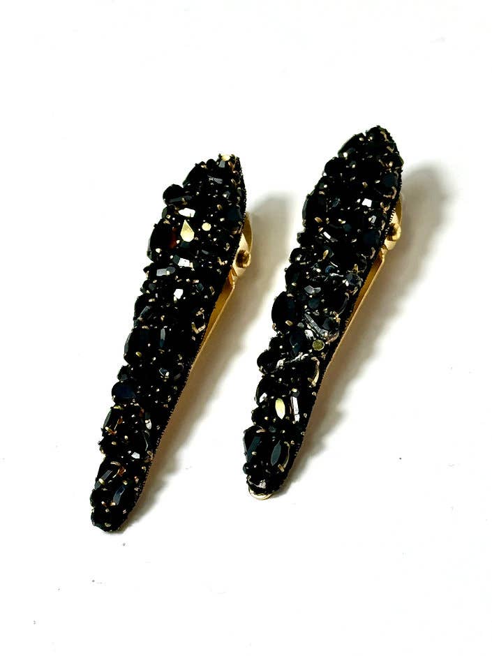 Pair of black stone earrings on a white background