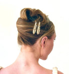 Woman with styled hair featuring a decorative hair clip on a white background
