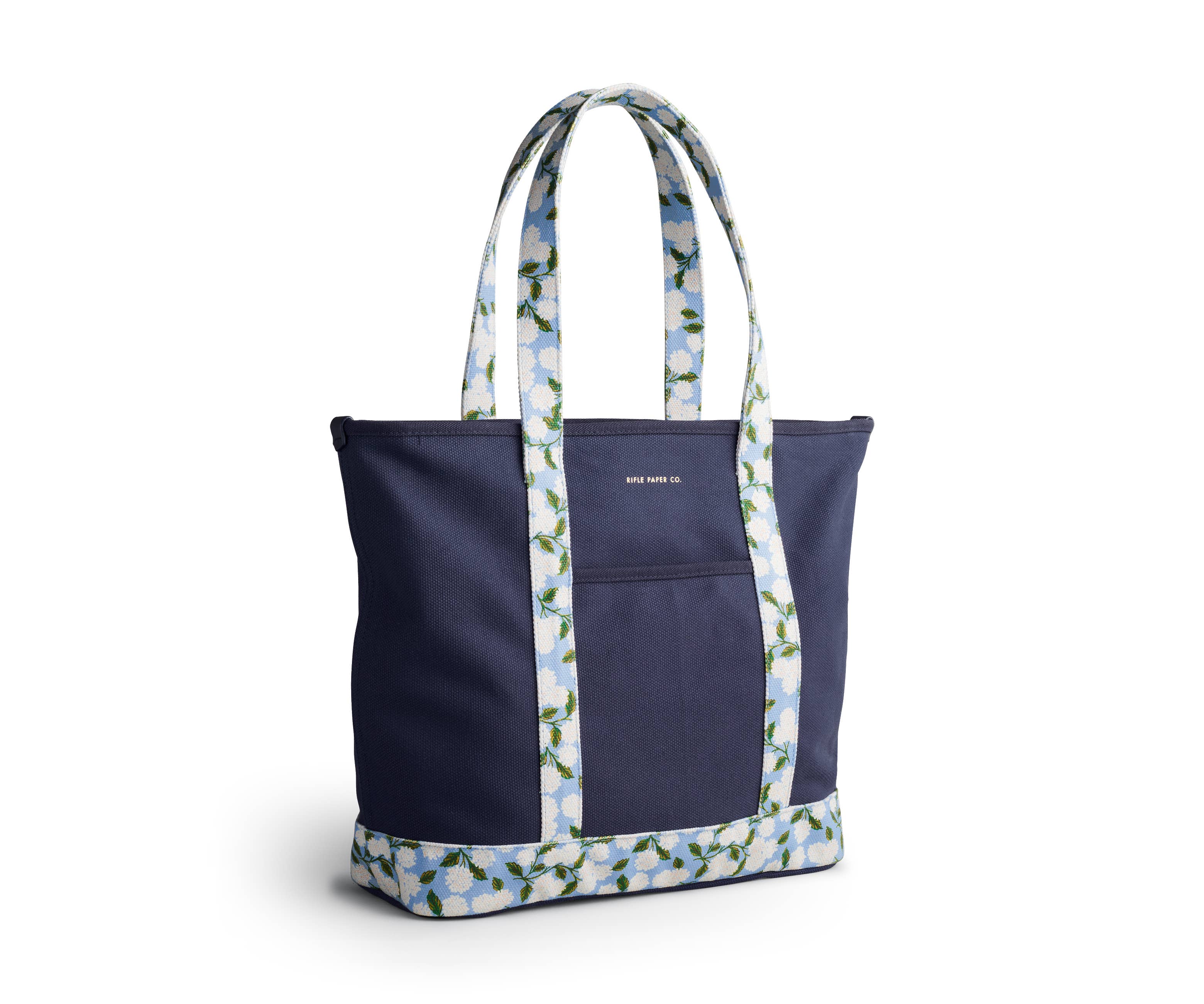 Navy tote bag with floral-patterned handles on a white background