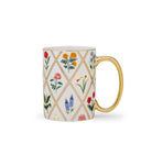Mug with floral pattern and gold handle on a white background